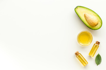 Avocado oil - skin care concept - on white background top-down frame copy space