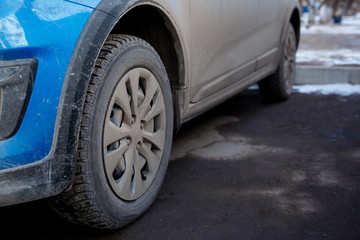 Naklejka premium dirt and dust on the body and wheels of a car, chemistry and salt