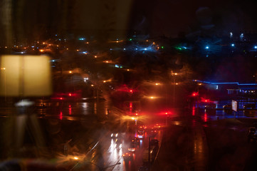 Photo of a night city from a window with beautiful colored lights