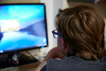 Photo of a young guy programmer working at a computer