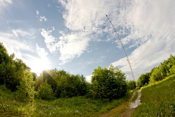 Tall tower in the forest under a blue sky