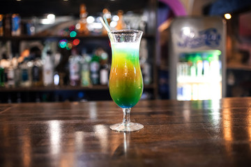 glass with a cool fruity cocktail with a straw