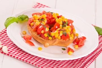 Friselle with tomatoes and mais.