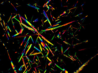 Crystal layer on microscope object glass, seen in polarized light. This causes random unforeseeable...