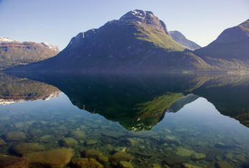Naklejka na ściany i meble Traveling Norway along the fjords with beautiful reflections