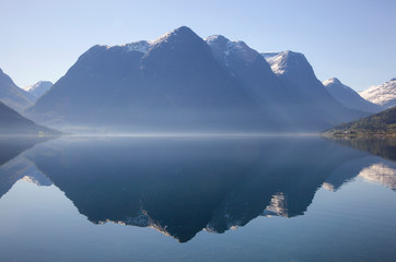Traveling Norway along the fjords with beautiful reflections