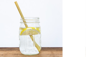 Lemon water and bamboo drinking straw.