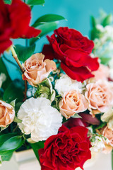 Decor of a stylish wedding ceremony. The decoration of the arch with red roses and wedding floristry. Modern trends in wedding bouquets.