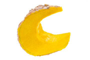 Slice of ripe yellow pumpkin on a white background.