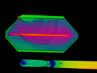 Thin layer of crystals of different chemicals seen in a microscope with polarized light.