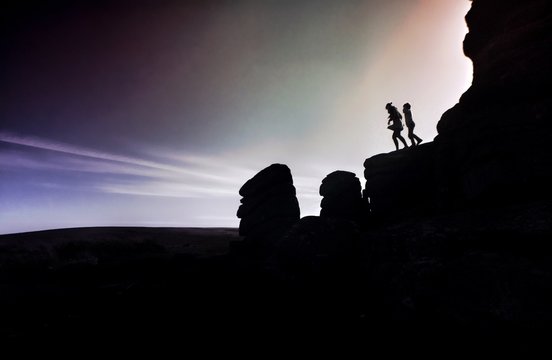 Silhouette People On Rocks Against Sky At Dartmoor National Park