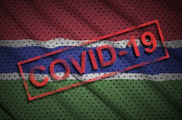Gambia flag and red Covid-19 stamp. Coronavirus 2019-nCov outbreak