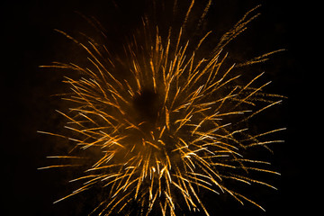 Yellow firecracker in the dark sky