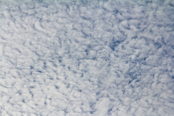 Backdrop from ragged clouds on a blue sky