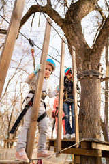 little girl fears climb in rope Park in the spring