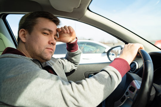 in traffic man in sweater behind wheel car rides