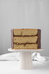 Cross section of an irish whiskey cake with irish cream and a chocolate ganache filling, view of inside a cake, st patrick's day  cake on a white cake stand