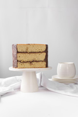 Cross section of an irish whiskey cake with irish cream and a chocolate ganache filling, view of inside a cake, st patrick's day  cake on a white cake stand