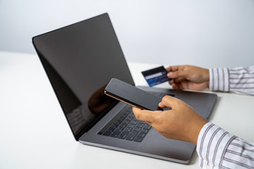 Person using online banking with credit card on touch screen device. Internet online banking. Digital and internet payments shopping on network. All on screen and credit card are designed up.