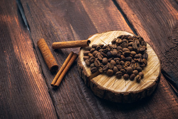Heart lined with coffee beans on a wooden vintage background, a symbol of love rustic style