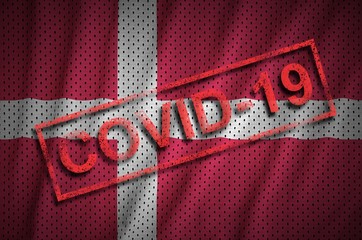 Denmark flag and red Covid-19 stamp. Coronavirus 2019-nCov outbreak