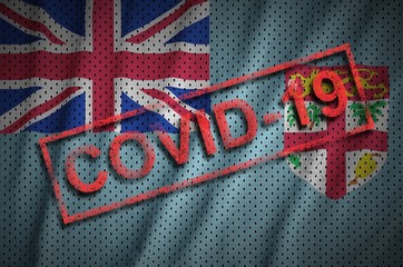 Fiji flag and red Covid-19 stamp. Coronavirus 2019-nCov outbreak