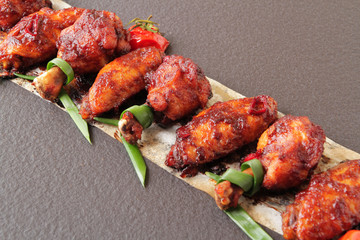  baked chicken wings with spices, tomato and soy sauce