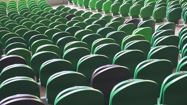 Empty plastic seats in a stadium. Matches to be played without fans.
