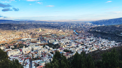 TBILISI, GEORGIA  DECEMBER 14, 2019:  Beautiful aerial view of the central part of city    and blue sky in Tbilisi, Georgia © Victoria Key