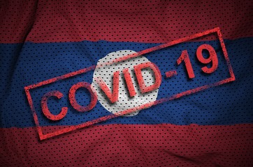 Laos flag and red Covid-19 stamp. Coronavirus 2019-nCov outbreak