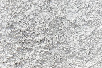White cement wall with ragged and dirty surface texture. The old and broken rough white concrete wall background.