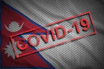 Nepal flag and red Covid-19 stamp. Coronavirus 2019-nCov outbreak