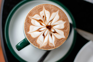 Top view of hot chocolate in a green cup 