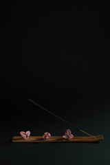 Natural medicine with aromatherapy. Smelling wand in a massage spa salon on a black background