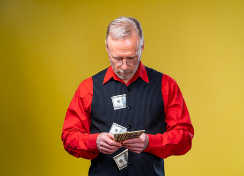 Much money in hands, dollars in hands. Man holds dollars. Piles of dollars bills. Cropped photo. Business concept.