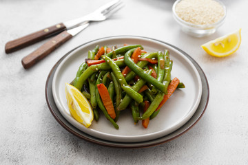 Vegan food. Cooked green string beans and carrots. Healthy salad of green beans and carrots close up.