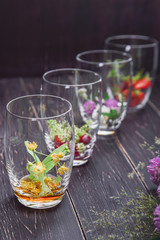 set for making medicinal tea in transparent glass glasses with medicinal herbs and fruits-Linden, cherry, strawberry, clover