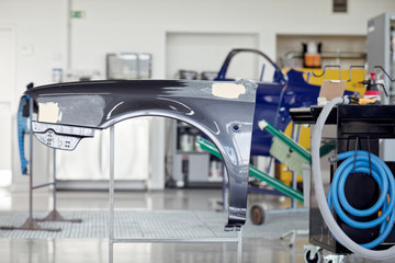 Car bodyshop front bumper repair painted gray