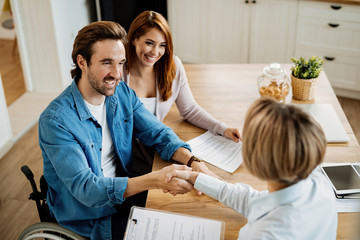 Young happy couple came to an agreement with their real estate agent.