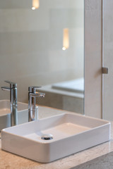 Modern faucet and white ceramic washbasin sink bathroom interior building decoration