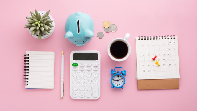 Piggy Bank, Coins, Calculator, Calendar, Clock, Notebook, Pen  On Pink Background, Saving Money Concept, Flat Lay