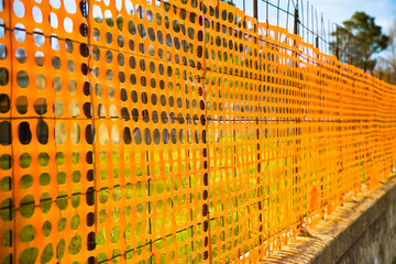 Orange construction grid around a construction site