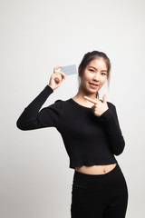 Young Asian woman point to a blank card.