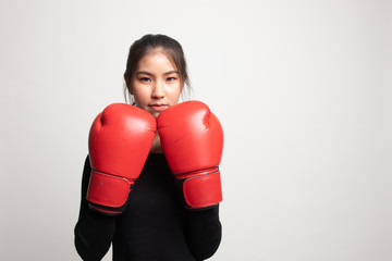 Young Asian woman with red boxing gloves.