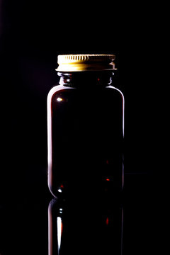 Dark brown bottle with metal cap