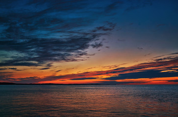 Beautiful colorful sunset on the Baltic Sea beach in the evening.