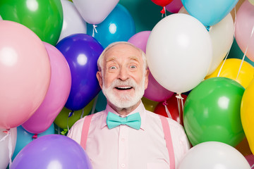 Close up photo astonished energetic crazy old man pensioner get many balloons enjoy party holiday...