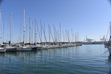 Fototapeta na wymiar The waters of the port with yachts ,white yacht on blue sea