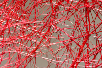 Part of a red wicker straw surface as a background abstraction Background dyed red weave from straw.