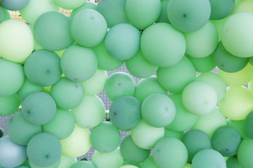 Green, light green and yellow balloons. A lot of balloons.